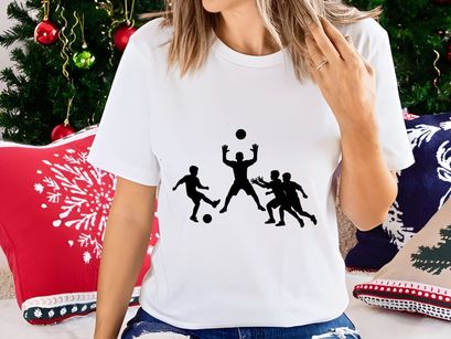 Silhouette of four men playing soccer or football with ball