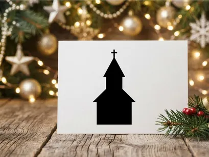 Black silhouette of a church building with a cross on a white background
