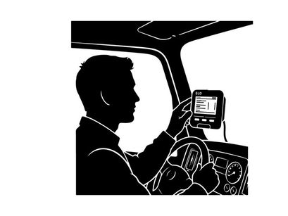 Silhouette of a man using a gps device while driving a car