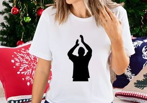 A silhouette of a person with their hands raised above their head in a gesture