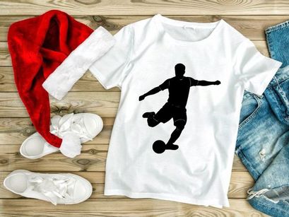 Soccer player kicking a ball in motion