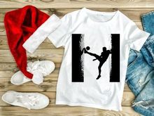 Silhouette of a soccer player kicking a ball in a dynamic pose