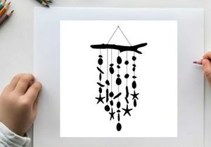 Silhouette of a driftwood wind chime with starfish and sea inspired shapes