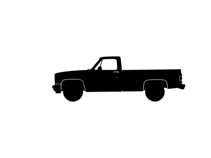 Silhouette of a classic pickup truck with a long bed and large tires