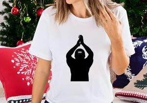 A person wearing a ski mask with hands raised above their head in a gesture