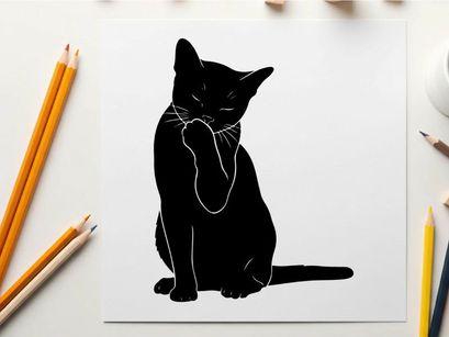 Silhouette of a black cat sitting and pawing at its face