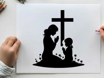 Silhouette of mother and child praying by cross