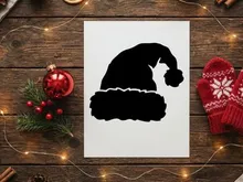 Silhouette of a cat sitting on a Christmas tree branch at night