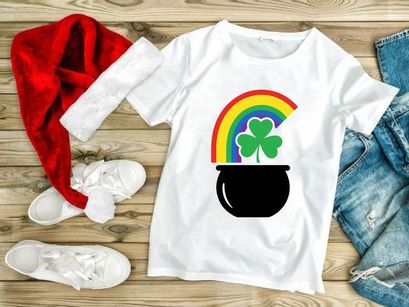 Lucky pot of gold with rainbow and shamrocks in black cauldron