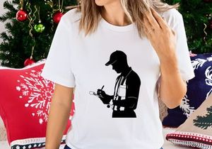Silhouette of a man in a cap writing on a clipboard with a pen