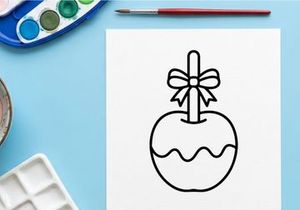 Hand-drawn apple with bow illustration for holiday gift tags. Simple black and white fruit sketch for seasonal branding and packaging design.
