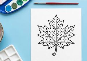 Decorative autumn maple leaf with intricate dotted design. Artistic botanical illustration for seasonal or nature-themed projects.