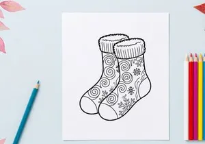 Pair of festive Christmas socks with snowflake and swirl patterns for holiday celebrations