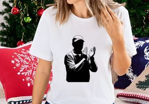 A black silhouette of a man in a baseball cap clapping his hands