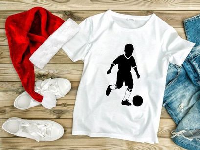 Silhouette of a boy playing soccer with a ball on a white background
