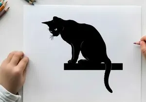 Black cat silhouette sitting on a ledge looking down