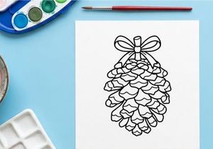 Decorative pine cone with ribbon for holiday decor. Elegant natural ornament for festive settings.
