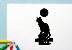 Silhouette of a cat sitting on a ledge with a full moon in the night sky