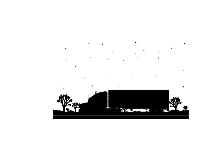 Truck driving on a road at dusk silhouette
