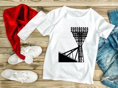 A large stadium light tower against a white sky background silhouette