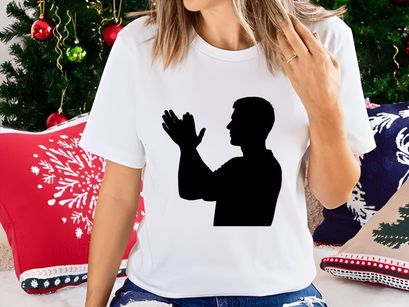 A man in silhouette with hands raised in a gesture of prayer or supplication