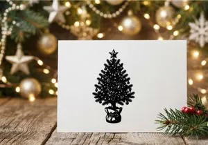 Black and white hand drawn Christmas tree illustration with ornaments and star topper.