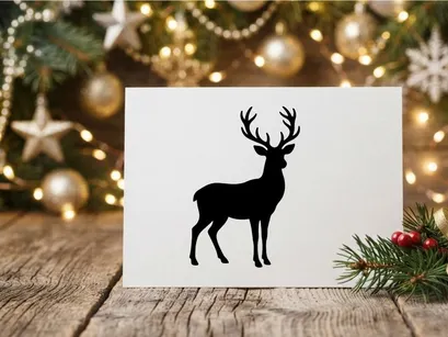 Black silhouette of a majestic reindeer with large antlers isolated on white background