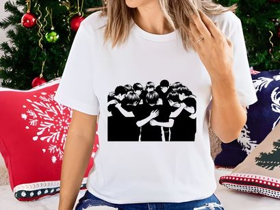 A group of young men in black shirts huddled together in a circle embracing