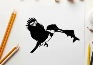 Silhouette of a bird catching a fish in mid air