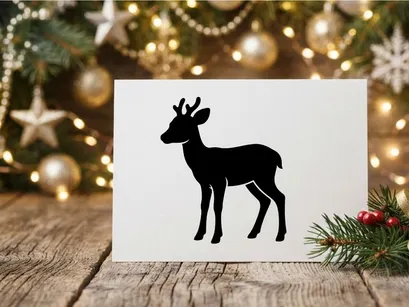 Black silhouette of a young deer with antlers isolated on a clean white background