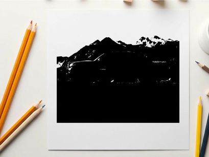 Silhouette of a pickup truck in front of a mountain range