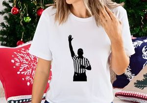 Referee in black and white silhouette signaling a call in sports