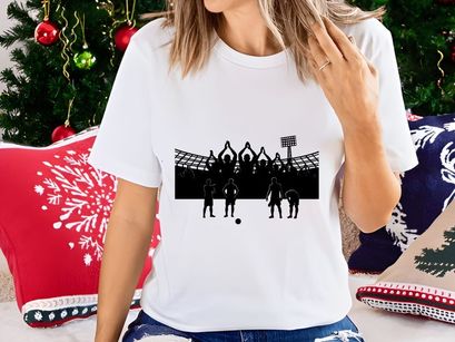 Silhouette of soccer players and fans in a stadium with raised hands