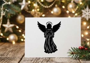 Black silhouette of a Christmas angel with wings and halo isolated on white background