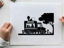 Silhouette of a man driving a truck with dogs and a tree