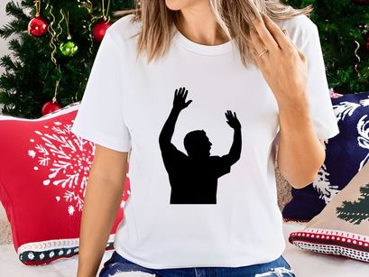 A silhouette of a man with his hands raised up in the air