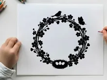 Silhouette of bird butterfly and floral wreath design