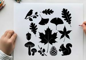 Silhouette of forest elements including leaves acorns and animals