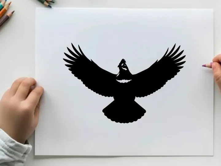 Silhouette of a bird in flight with outstretched wings
