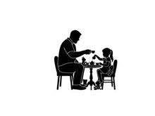 Silhouette of a man and child playing chess together at a small table