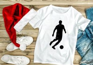 Soccer player kicking a ball in action silhouette