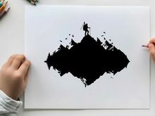 Silhouette of a hiker on a mountain peak at sunset