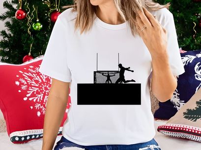 Silhouette of a person running past a goal with another figure in the background