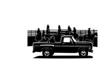 Silhouette of a pickup truck parked near a fence with people and umbrellas