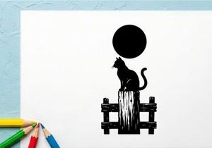 Silhouette of a cat sitting on a wooden fence with a full moon overhead