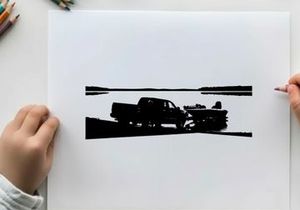 Silhouette of a pickup truck towing a boat on a road by the water