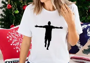 Silhouette of a man in a t shirt and shorts with arms outstretched in mid air