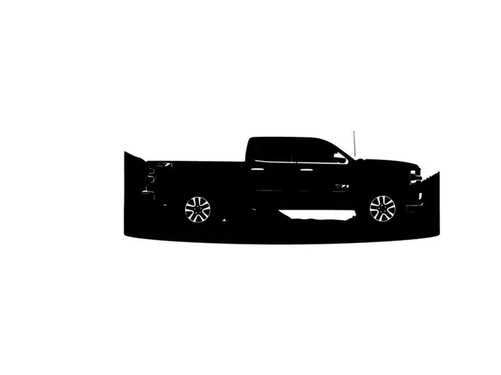 Silhouette of a pickup truck against a mountain range silhouette