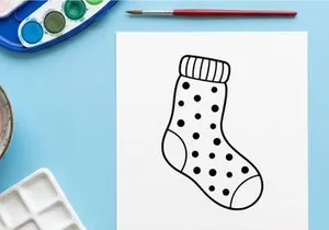Christmas stocking icon with polka dot pattern, simple black and white line art drawing.