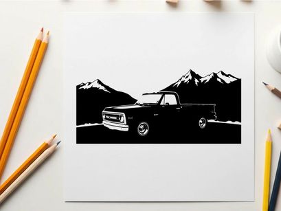 Silhouette of a pickup truck in front of mountains